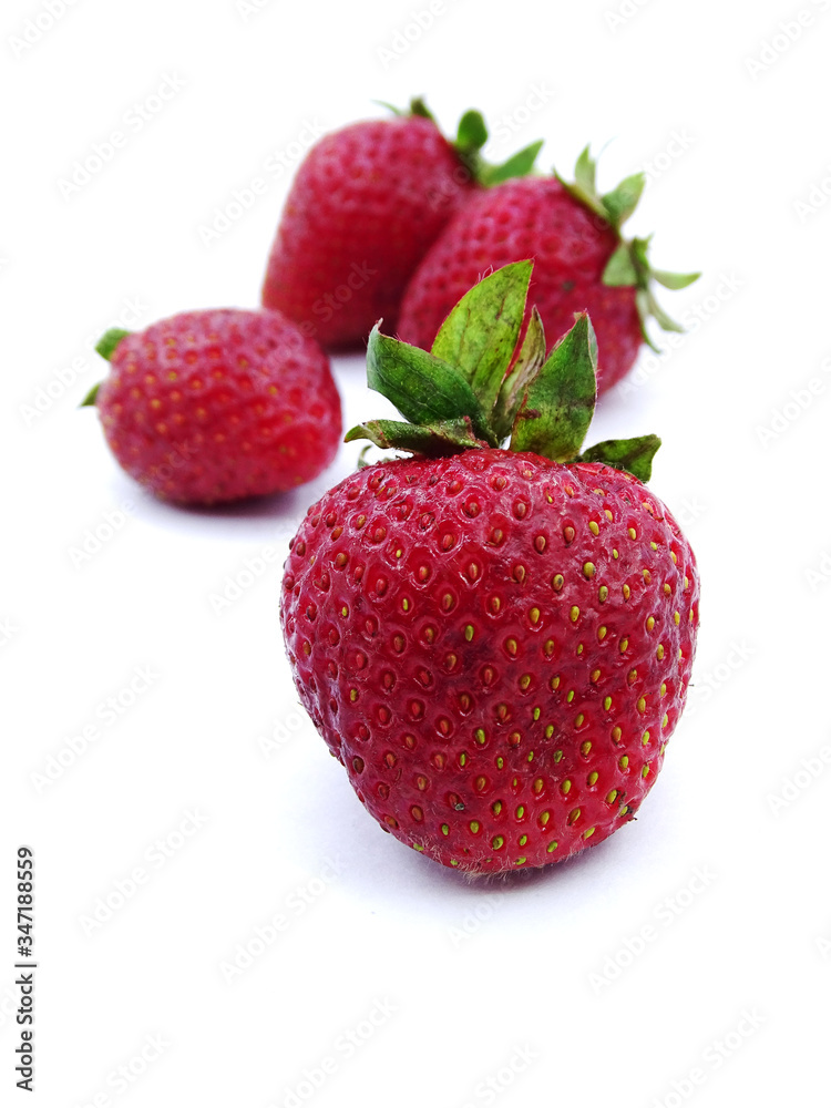 Organic strawberries from the field in white and black background Organic strawberries from the field in white and black background