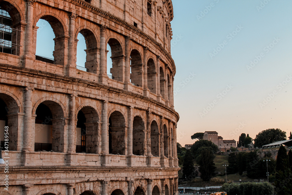 colosseum in rome italy  on the sunset against the background of the landscape