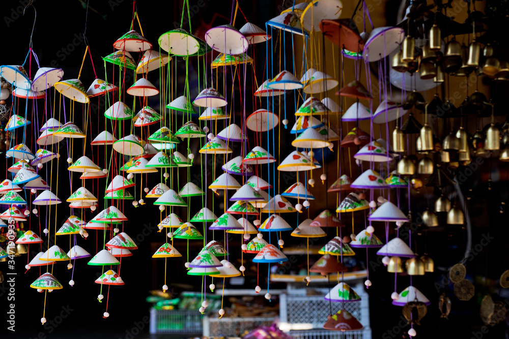 Colorful Souvenirs with bells hang on the front of a store in Hoi an Old town. Vietnam