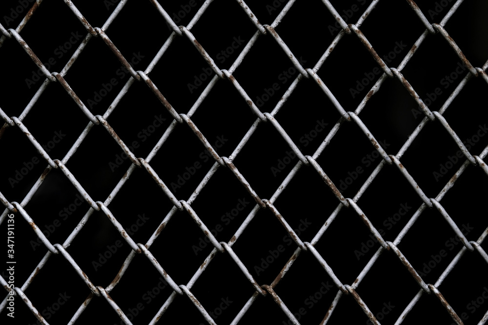 Old rust chain link fence metal wire mesh panel. Black background. Old rust chain link fence metal wire mesh panel. Black background.
