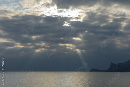 Sunrays are through the clouds over Black Sea, Crimea, Russia.
