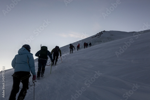A huge line of alpinists ascending to the Mont-Blanc via the Aiguille du Goûter. French Alps, Chamonix-Mont-Blanc, France