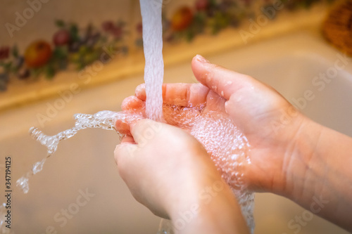 splashing running water whilst washing hands to keep them clean and free from germs