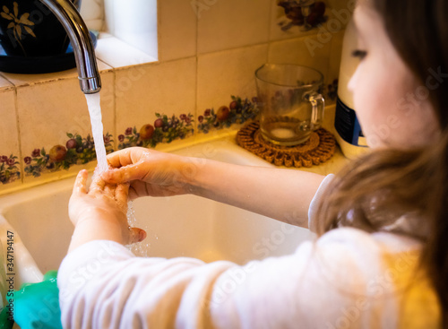 washing hands to keep them clean and free from germs in the kitchen after cooking