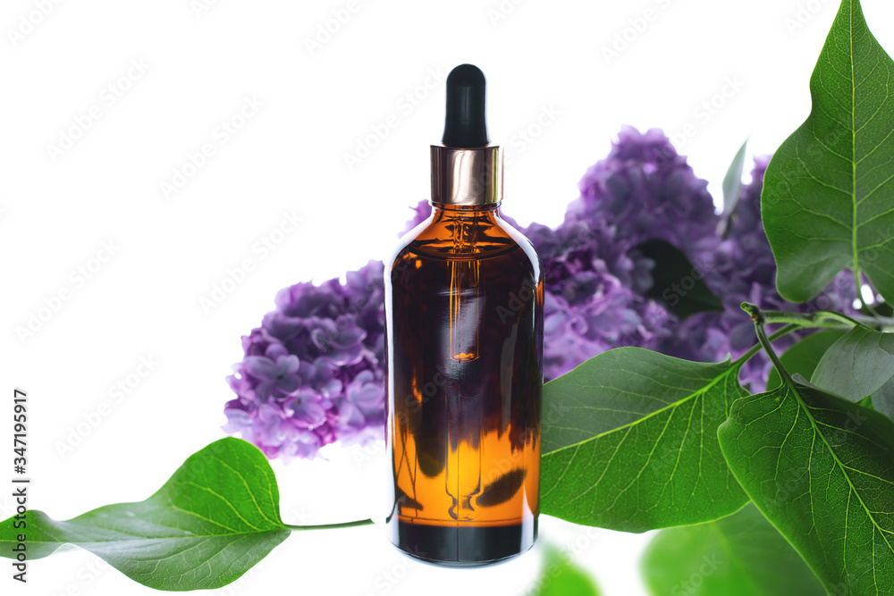 Organic natural oil in a brown bottle with flowers