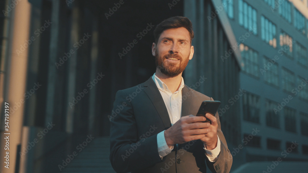 Shot move around businessman stand in the city center street uses phone texting scrolling tapping smile technology communication sunny day success slow motion Shot move around businessman stand in the city center street uses phone texting scrolling tapping smile technology communication sunny day success slow motion