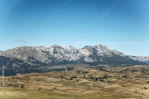 Beautiful panoramic view of the mountains and rural landscape against the blue sky in Montenegro.