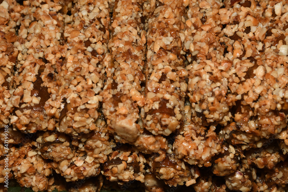 Cevizli sucuk made by dipping a string with walnuts into a grape molasses mixture Cevizli sucuk made by dipping a string with walnuts into a grape molasses mixture