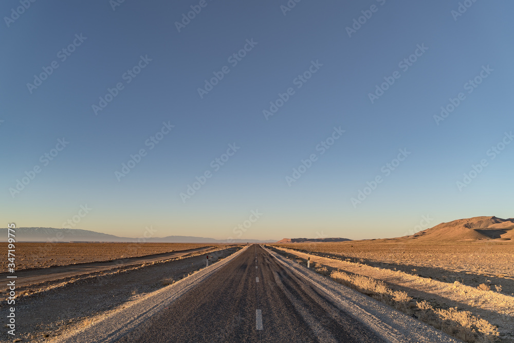 Fototapeta premium road at dawn in the Sahara desert in North Africa