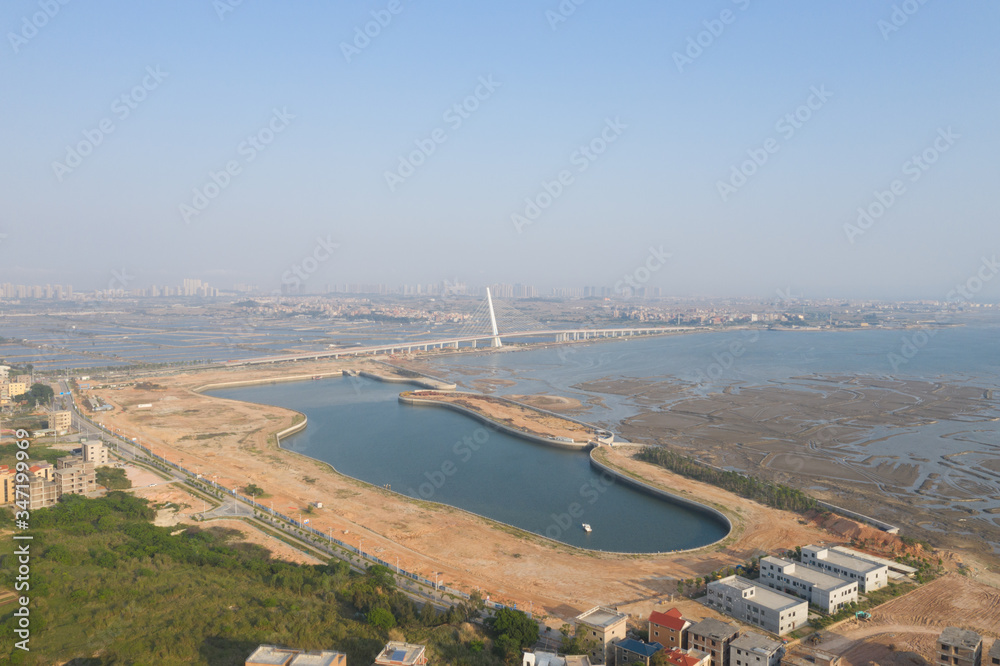 Aerial view of a Chinese traditional fishing village around Xiamen city, with residential buildings and fishing boats