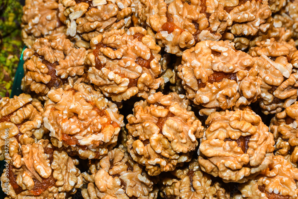 Turkish fruit and nut balls candy. Scattered pistachio and almond nuts Turkish fruit and nut balls candy. Scattered pistachio and almond nuts