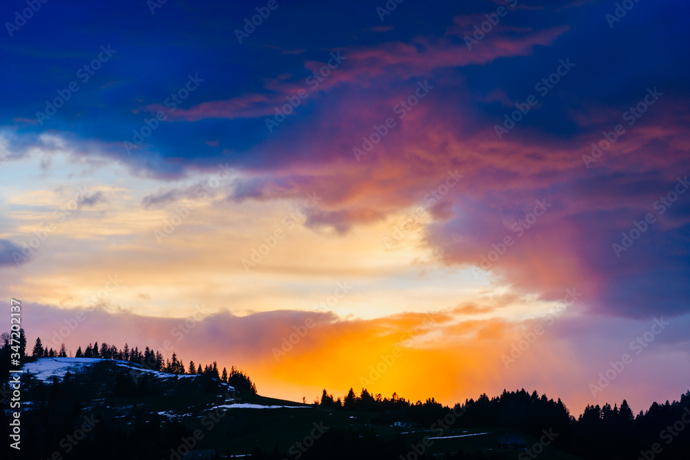 It's a great sunset. Landscape of beautiful multicolored evening sky over the forest