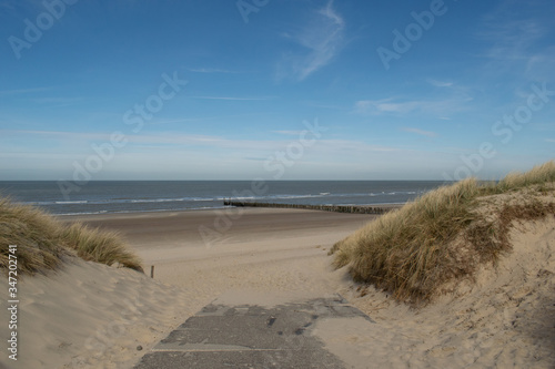 Sand dunes near to the sea with blue sky