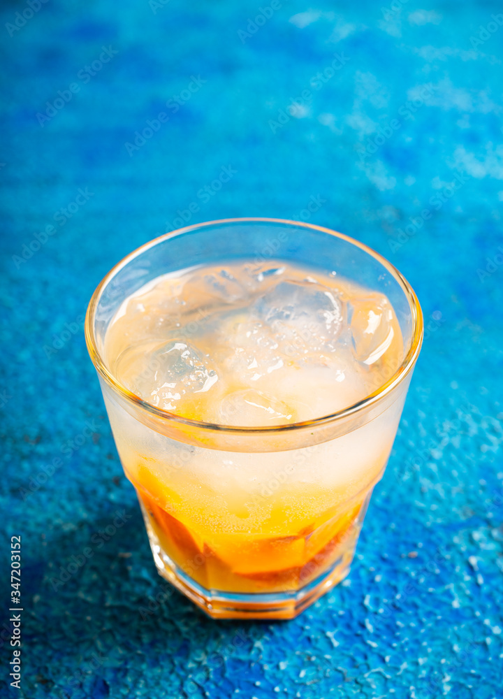 Old fashioned beverage with orange slices on rustic background. Selective focus. Shallow depth of field. Old fashioned beverage with orange slices on rustic background. Selective focus. Shallow depth of field.