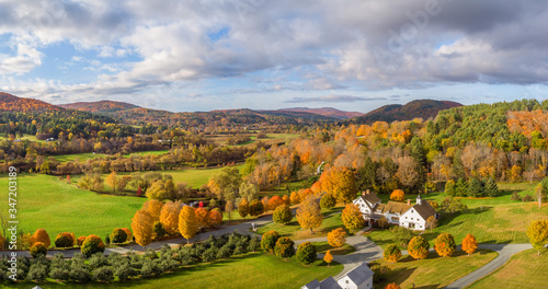 Fototapeta Autumn leaves on country farm road near Woodstock Vermont