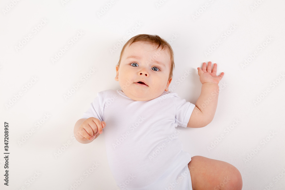 portrait of a cute baby boy with blue eyes in a white bodysuit against a white background, space for text portrait of a cute baby boy with blue eyes in a white bodysuit against a white background, space for text