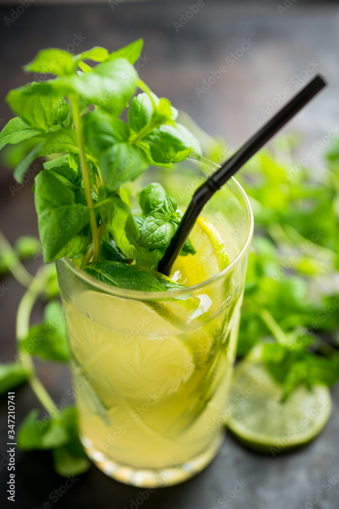 Mojito cocktail with lime and mint on the rustic background. Selective focus. Shallow depth of field. Mojito cocktail with lime and mint on the rustic background. Selective focus. Shallow depth of field.