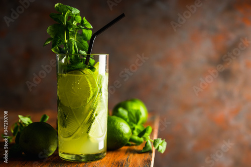 Mojito cocktail with lime and mint on the rustic background. Selective focus. Shallow depth of field.