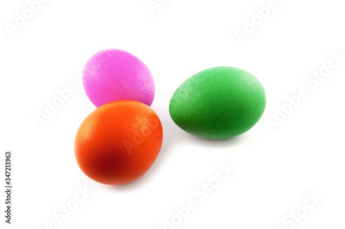 Three easter eggs, red and green, orange or yellow, isolated on white background, colored by easter bunny