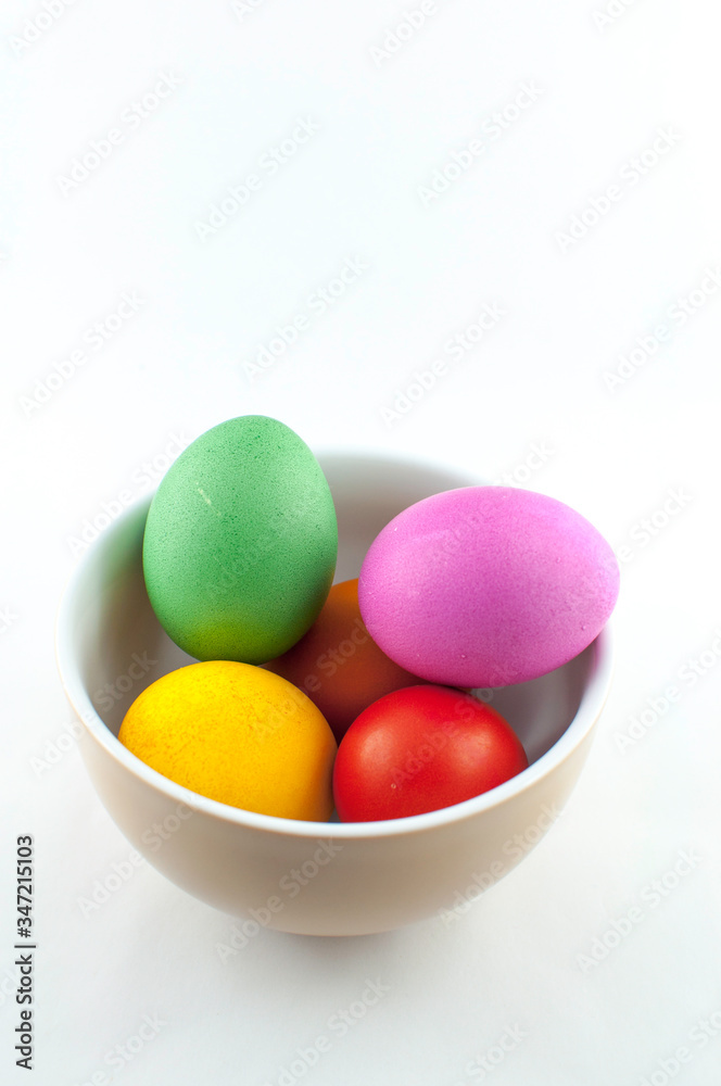 A ceramic bowl full of Easter eggs. The Easter bunny hid the eggs, the children looked for and found the eggs in the morning. There will be Easter breakfast soon. A ceramic bowl full of Easter eggs. The Easter bunny hid the eggs, the children looked for and found the eggs in the morning. There will be Easter breakfast soon.