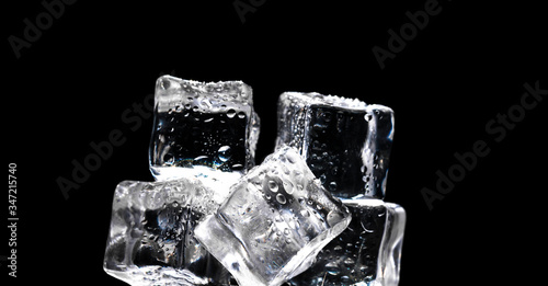 ice cubes with drops of water on a black background