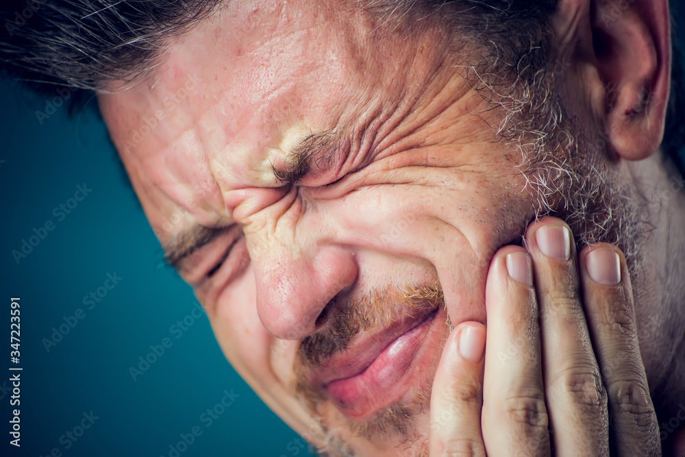 Fototapeta premium A man feeling toothache. Close up. People, healthcare and medicine concept.