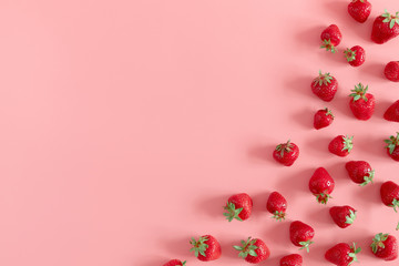 Strawberries on pink background. Strawberries berries pattern. Creative food concept. Flat lay, top view, copy space 