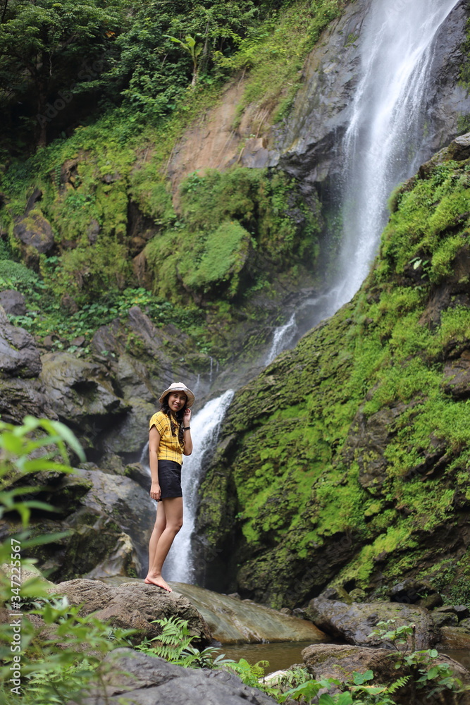 Women enjoying nature at Klong Lan waterfall in Klong Lan national park at Kamphaeng Phet, Thailand	