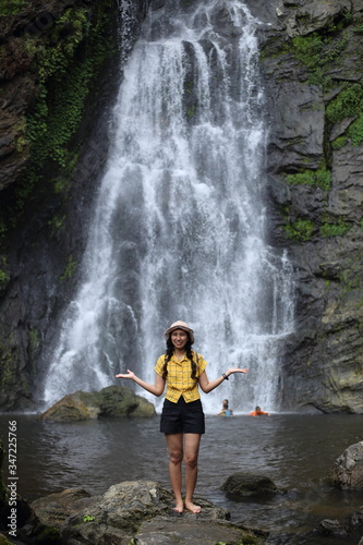 Women enjoying nature at Klong Lan waterfall in Klong Lan national park at Kamphaeng Phet, Thailand 
