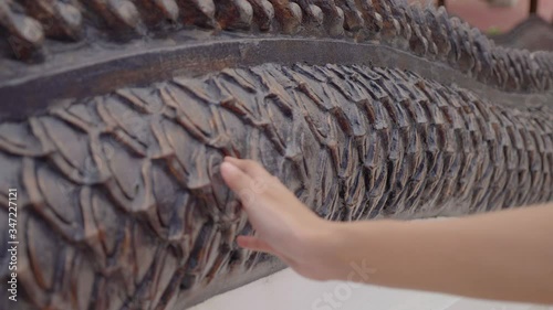 Hand close up of female hand with Architectural pattern to travel , Ancient city thailand 

