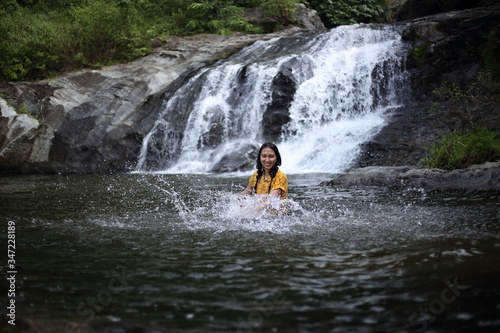 Women enjoying playing in the water at Khlong Nam Lai waterfall in Klong Lan national park  Kamphaeng Phet  Thailand