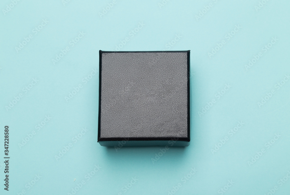 Mini black box product packaging isolated on blue background. Flat lay Top view. Mini black box product packaging isolated on blue background. Flat lay Top view.