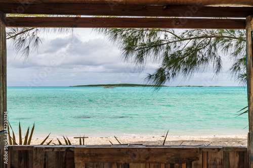 Photo View of Coco Plum beach through the window of a small wooden house (Great Exuma,  Bahamas)