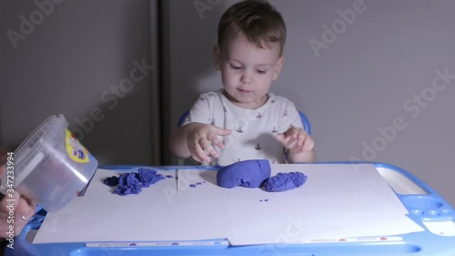 Little beautiful child plays, child plays with father at home