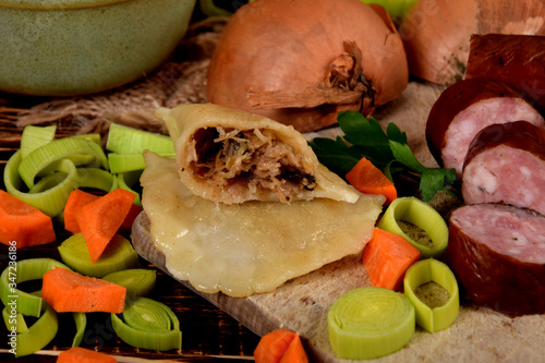 center of dumpling with cabbage stuffing next to smoked sausage photo