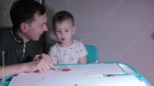 Little beautiful child plays, child plays with father at home
