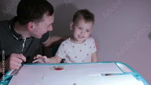 Little beautiful child plays, child plays with father at home