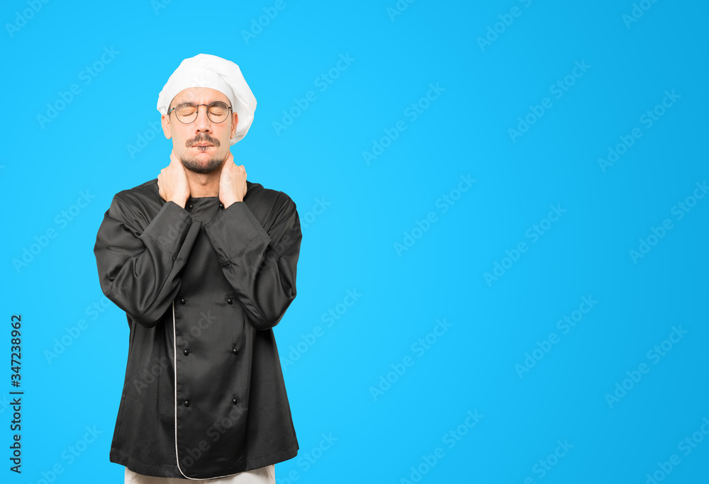 Depressed young chef doing a gesture of stress Depressed young chef doing a gesture of stress