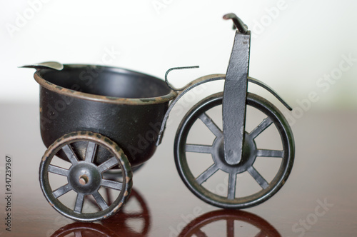 small antique shelf ornament, a black bicycle bike with a storage compartment