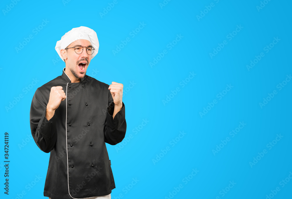 Upset young chef doing a competitive gesture