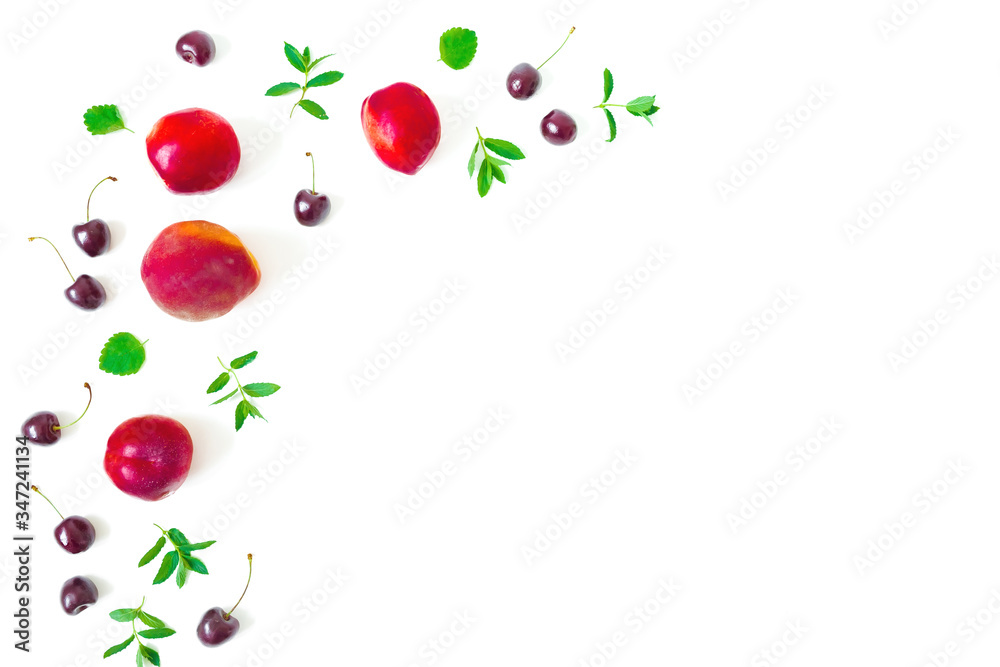 Peaches with cherry and mint leaves on white background. Summer food frame. Top view Peaches with cherry and mint leaves on white background. Summer food frame. Top view