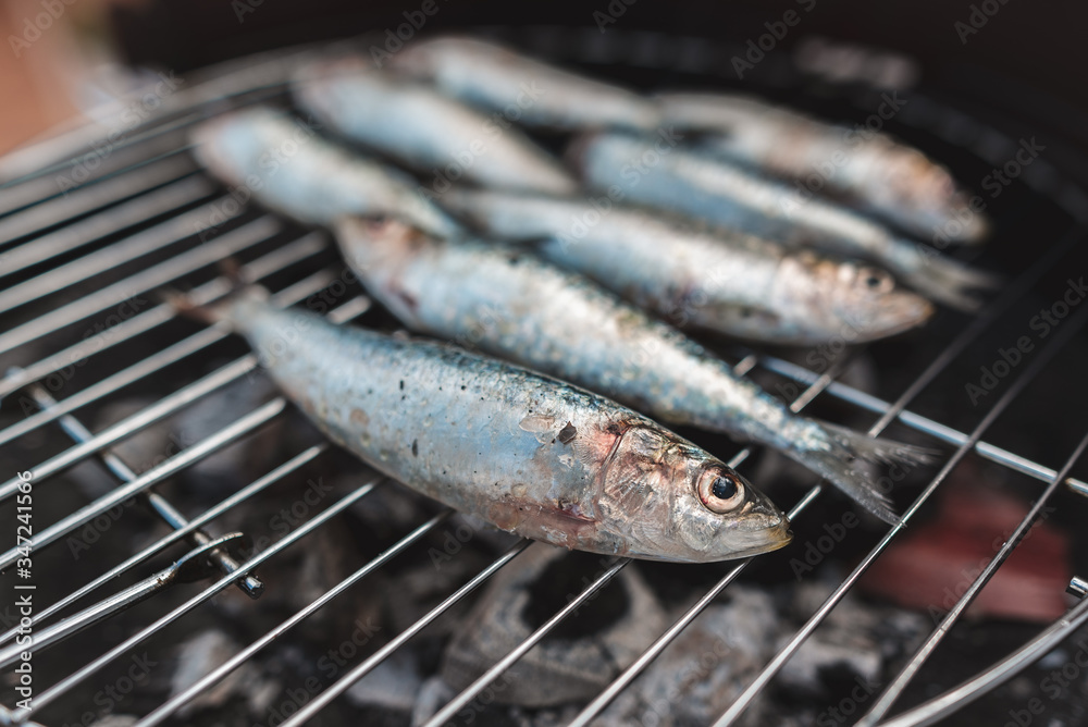 Fresh raw Sardines prepared for the Grill. Grilled Sardines On Hot Coal. Healthy food concept. Mediterranean cuisine. Typical dishes of the Spanish and Portuguese coasts. Close - up.