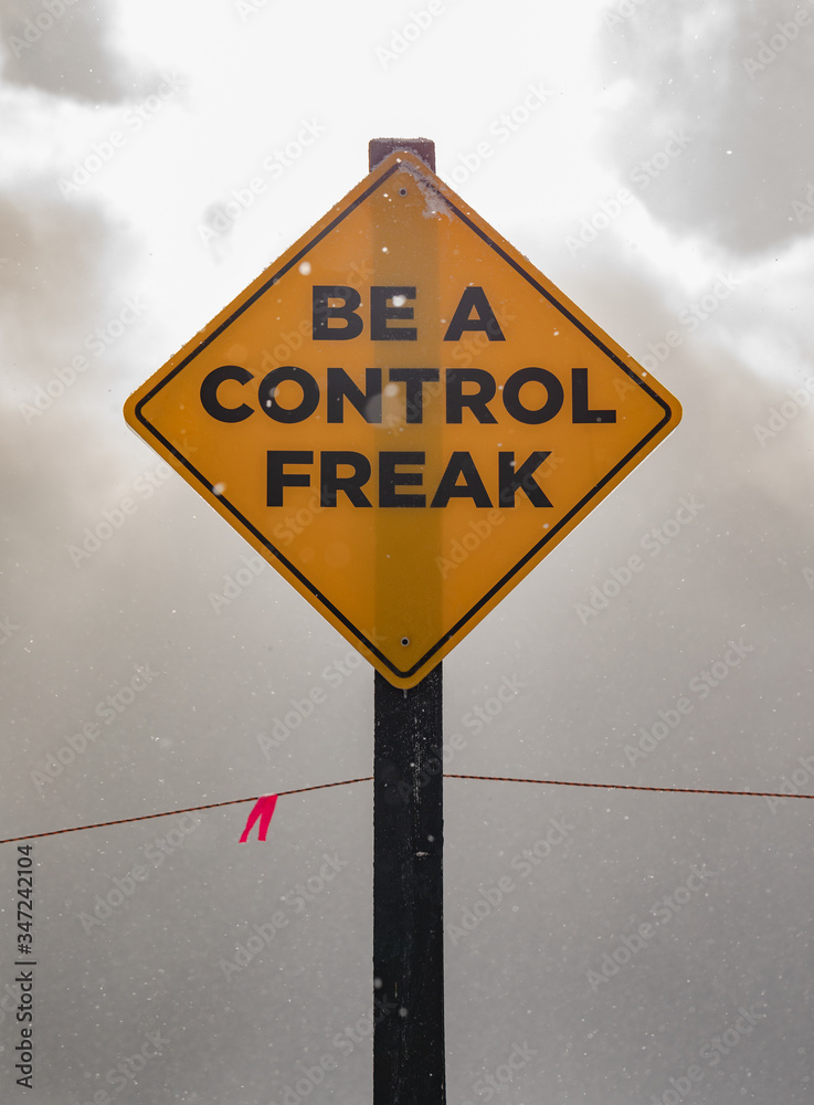 Caution sign: be a control freak (close up)