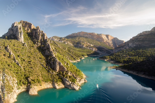 Boat across Mont Rebei canyon in the morning, Lleida, Spain photo