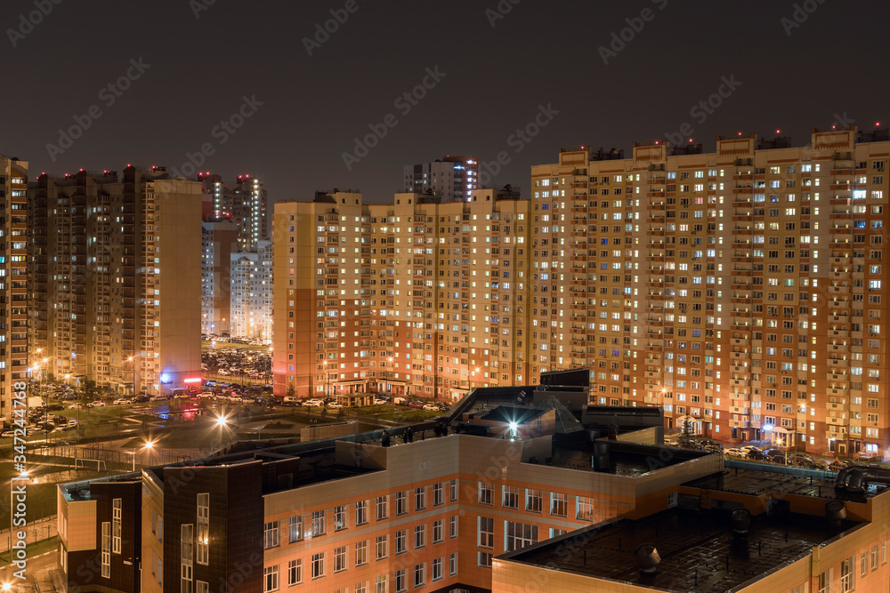 Butovo Park, Leninsky district of Moscow region, Russia-2020 . An area with numerous residential buildings. Suburbs. Suburban town in lights. Multicolored light in the Windows. Evening in the city.