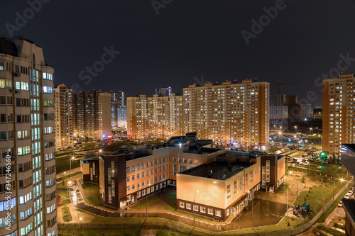 Butovo Park, Leninsky district of Moscow region, Russia-2020 . An area with numerous residential buildings. Suburbs. Suburban town in lights. Multicolored light in the Windows. Evening in the city. photo