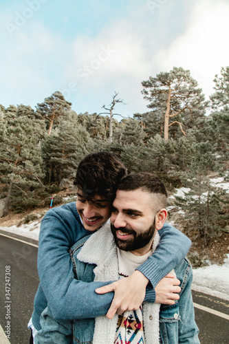 Gay couple in love on a mountain road