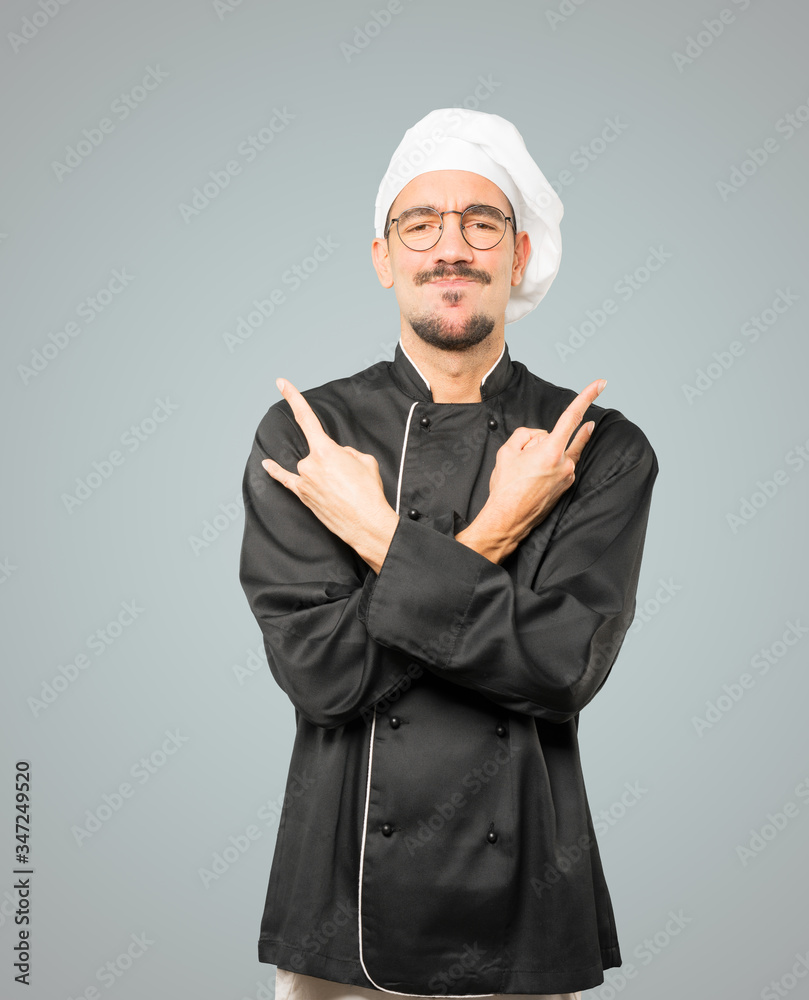 Naughty young chef making a rock gesture