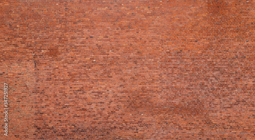 Big old red brick wall. Full frame textured background of detailed old and weathered brick wall.