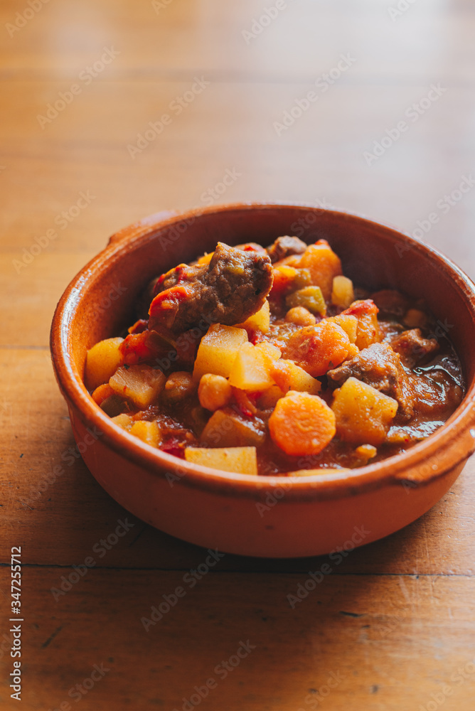 potatoes and meat stew on a clay container potatoes and meat stew on a clay container